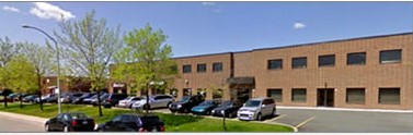 Office building with cars parked in front